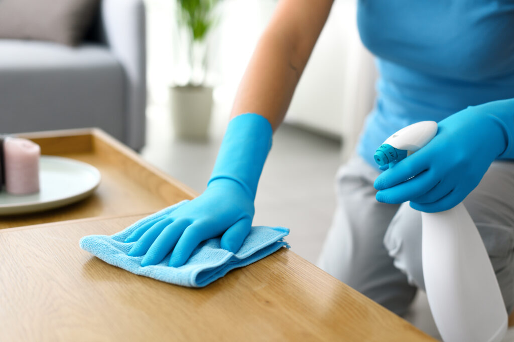 Woman cleaning a table at home